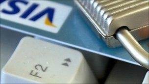 Padlock and a credit card on a computer keyboard