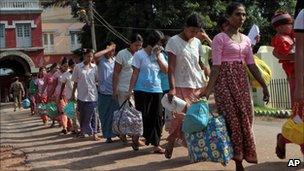 Prisoners walk out Burma's Insein prison after they were released under a government amnesty