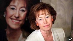 Berlusconi ally and incumbent mayor of Milan Letizia Moratti faces reporters in front of her own poster, 16 May