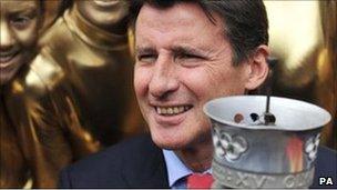 London 2012 chairman Lord Coe holding an Olympic Torch