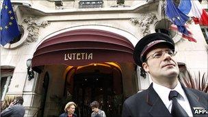 Bellboy stands outside Paris hotel