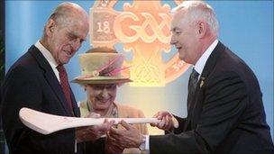 The Queen and Duke of Edinburgh are presented with a hurley