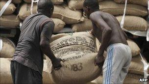 Workers move cocoa sacks at Abidjan's port, 8 May 2011