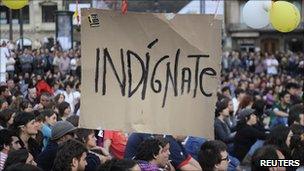 A placard hangs above protesters in the Plaza Arriaga in Bilbao, 19 May, 2011