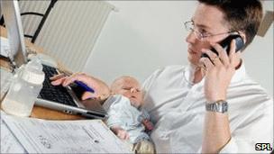 Dad with baby at his computer