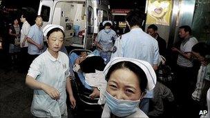 An injured man from the Foxconn factory explosion in Chengdu is carried to hospital