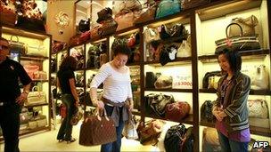 A shopper tries out a bag in a Milan Station store