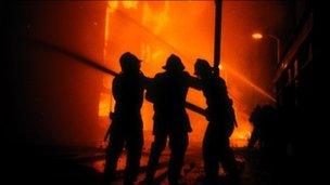 Firefighters trying to put out a fire during the Brixton Riot