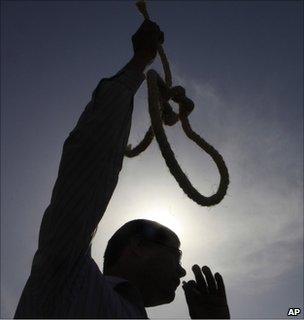 Egyptian protester waves a mock noose