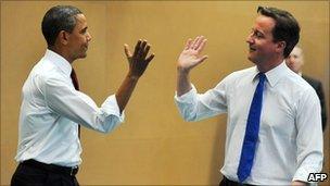 President Barack Obama high-fives with Prime Minister David Cameron