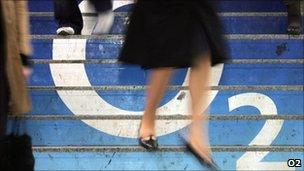 A woman walks over an o2 logo