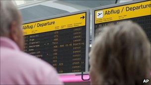 Passengers view cancelled flights at Tegel Airport in Berlin, Germany, 25 May 2011