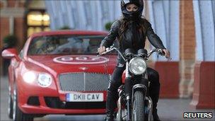 Model Chesca Miles arrives on a BSA Spitfire motor-bike to launch the new James Bond book "Carte Blanche" at St Pancras station