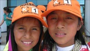 Indigenous Kichwa girls wearing trademark orange baseball caps of Keiko Fujimori's party