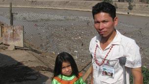 Jonas Ahuanari and his daughter, Zamme, by Lima's river Rimac