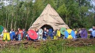 Children around the Iron Age Roundhouse