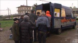 People queue for food from the night bus