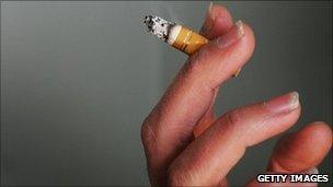 A hand holding a cigarette