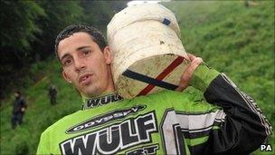 Chris Anderson, 23, from Brockworth holds his prize cheeses after he won all three races