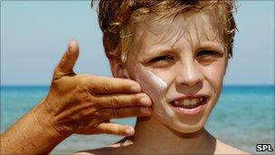 Sun cream being applied