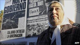 Hebe de Bonafini, president of the Madres de Plaza de Mayo, poses next to a banner with the frontpages of Clarin newspaper published during the last Argentine dictatorship (1976-1983), at Plaza de Mayo square in Buenos Aires on 29 April, 2010.