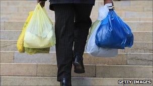 Shopper carrying plastic bags