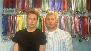 Jon Levart and son Ben with his swimming medals