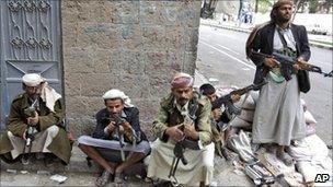 Armed tribesmen loyal to Sheikh Sadeq al-Ahmar, the head of the powerful Hashid tribe, take positions near his house in Sanaa, Yemen, 26 May 2011