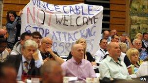 GMB members hold up banner saying Vince Cable "not welcome"