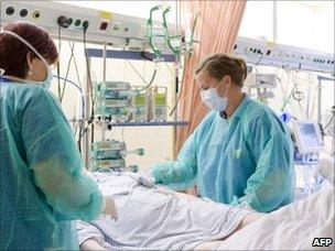 Nurses tend to a patient infected with enterohaemorrhagic E. coli (EHEC) in the intensive care unit of the northern German city of Luebeck (7 June 2011)