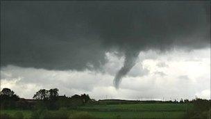 Funnel cloud over fields