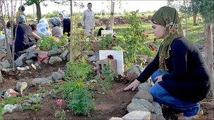 Kurdish women tend the graves of PKK fighters