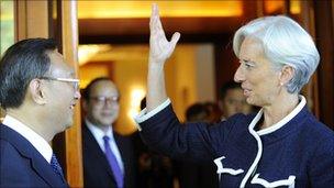 French finance minister Christine Lagarde (R) talks to Chinese Foreign Minister Yang Jiechi