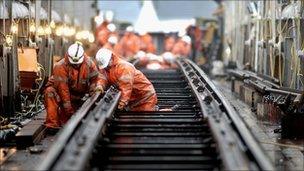 Rail workers laying track