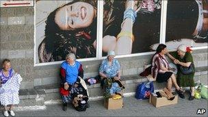 Elderly women sell clothes outside a supermarket in Minsk to make ends meet, 8 June