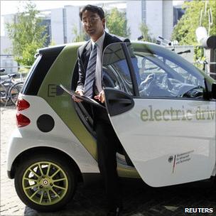 German economic minister Philipp Roesler with electric car