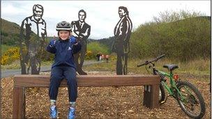 Cyclist Sebastion next to the sculpture