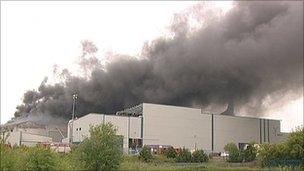 Fire crews remain at Sonae wood chippings factory fire - BBC News