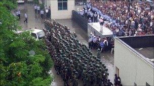 Chinese riot police deployed to prevent crowds breaking into the local government compound in Lichuan, Hubei province - 9 June 2011