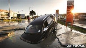 A car stands in water on Ferry Road after two magnitude 6.0 and 5.5 earthquakes struck on June 13, 2011 in Christchurch, New Zealand