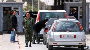 Tunisian soldier checks vehicles on the Tunisian-Libyan border in Dehiba in April 2011
