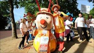 Lloyd Scott surrounded by Magic Roundabout characters.