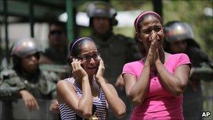 Relatives cry outside the prison on 13 June 2011