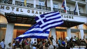 Protesters wave Greek flags in front of the Grande Bretagne hotel on Syntagma Square, Athens, Greece, 14 June 2011