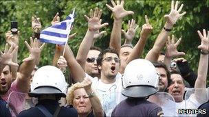 Demonstrators confront riot police near the Greek parliament in Athens, 15 June 2011