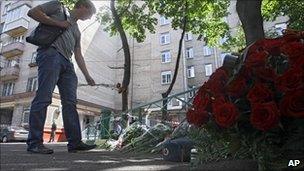 A man lays flowers at the spot in Moscow where Yuri Budanov was killed, 11 June