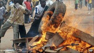 Ugandan protesters burn tyres in Kampala in anger at the manner of opposition leader Kizza Besigye's arrest in April