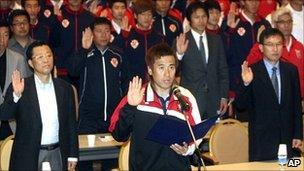 South Korean K-League Gyeongnam FC goalkeeper Kim Byung-ji, front, takes an oath with other players, coaches and referees, to end match fixing during a workshop in Pyeongchang, South Korea.