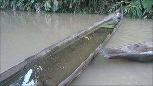 Wooden canoe at the water's edge