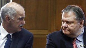 Greek Prime Minister George Papandreou (left) talks to newly appointed Finance Minister Evangelos Venizelos before a cabinet meeting at the parliament in Athens, 17 June 2011